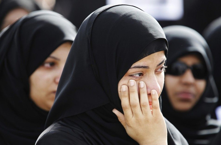 A relative of a protester, who was killed in Thursday's crackdown, mourns during a funeral procession in Sitra, east of Manama