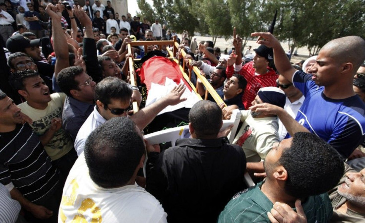 The body of a protester is taken for burial as his family members and supporters follow in Sitra