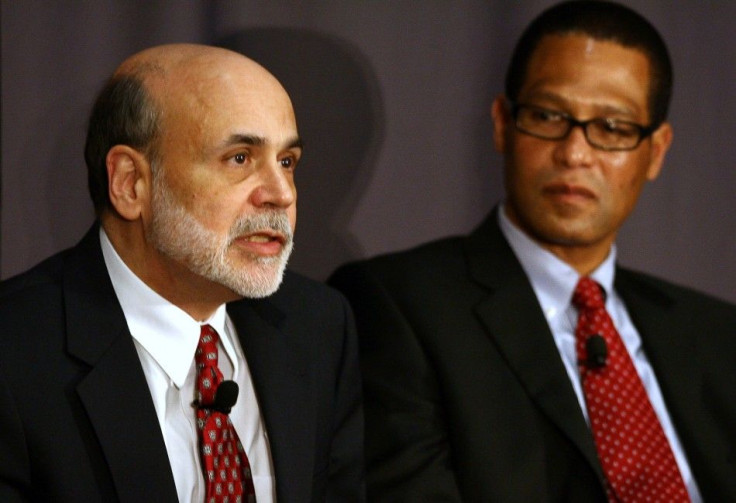 Fed Reserve Chairman Bernanke speaks as CEO of Sophisticated Systems Smith looks on during a discussion at The Ohio State University