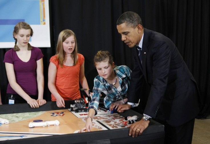 U.S. President Barack Obama watches a Lego robot as he meets student finalists of Intel's Science Talent Search in Hillsboro