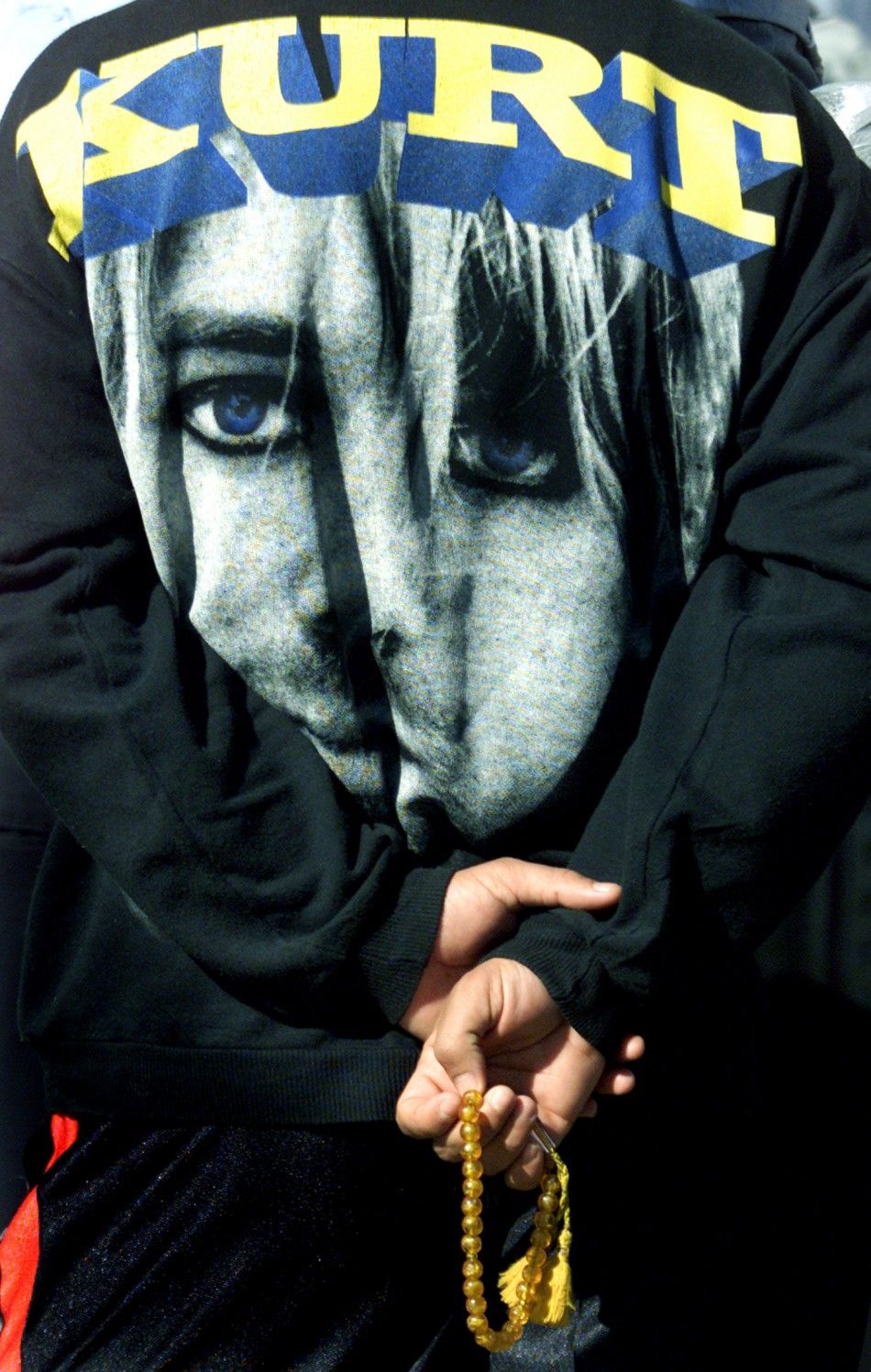 An Iraqi policeman, wearing a shirt emblazoned with a picture of the rock band Nirvanas late frontman Kurt Cobain, during a 2003 demonstration in Baghdad