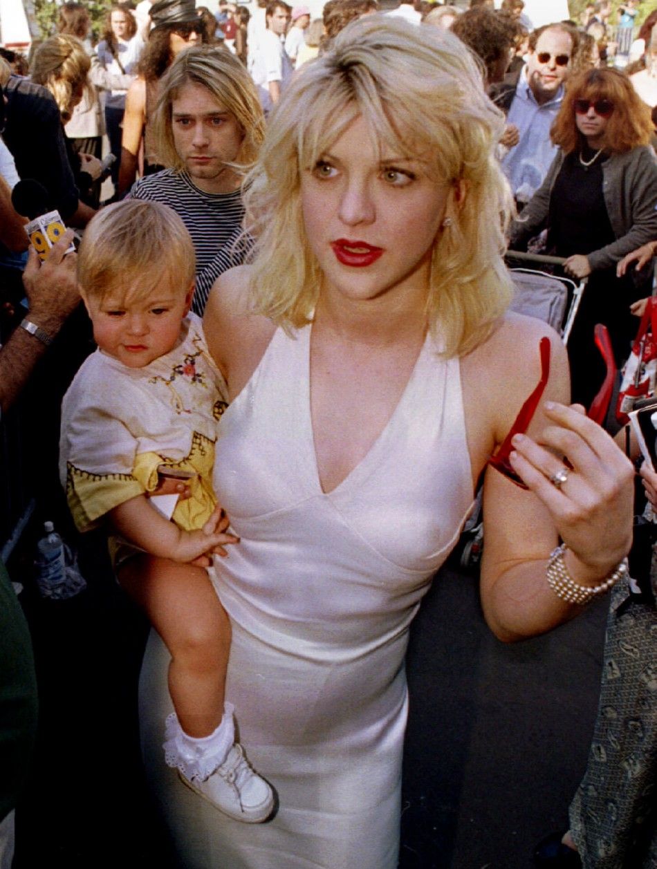 FILE PHOTO SEP 92- Kurt Cobain L, behind baby, is shown as he arrives with wife Courtney Love, holding their daughter Frances Bean Cobain, for the MTV Music Awards show in September 1992 in Los Angeles