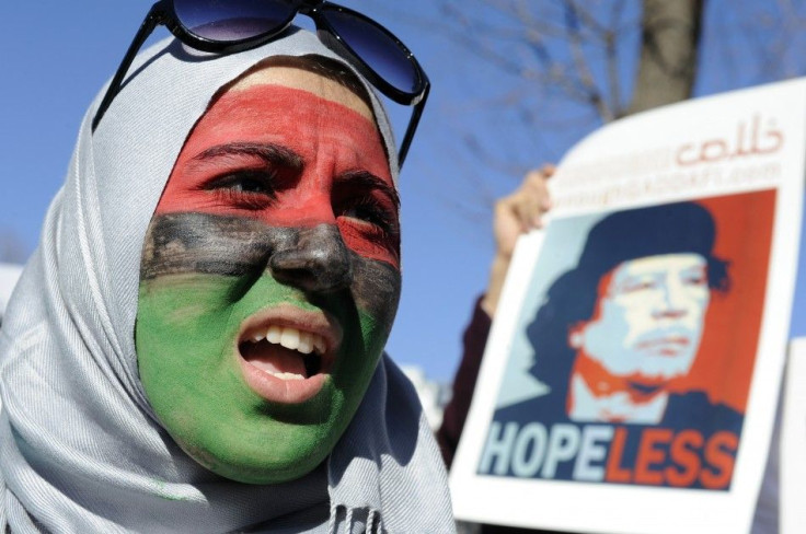 Woman with her face painted in colours of Libyan flag joins demonstration against rule of Libya's leader Gaddafi, in front of White House in Washington