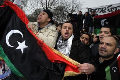 Demonstrators protest against Libya's Muammar Gaddafi outside the Libyan Embassy in London