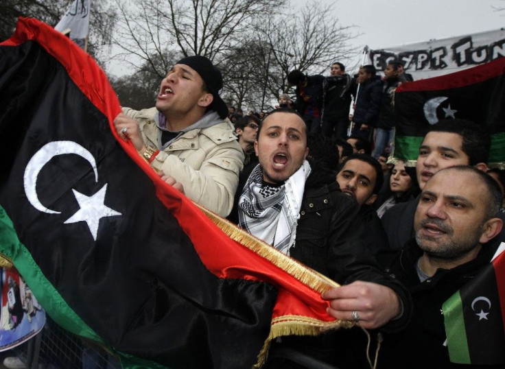 Demonstrators protest against Libya's Muammar Gaddafi outside the Libyan Embassy in London