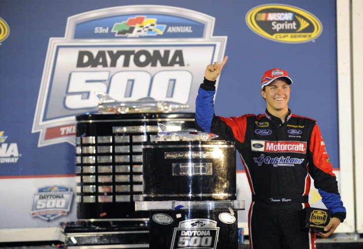 Sprint Cup Series driver Bayne stands next to the trophy in victory lane after winning the NASCAR Sprint Cup Series Daytona 500 race.