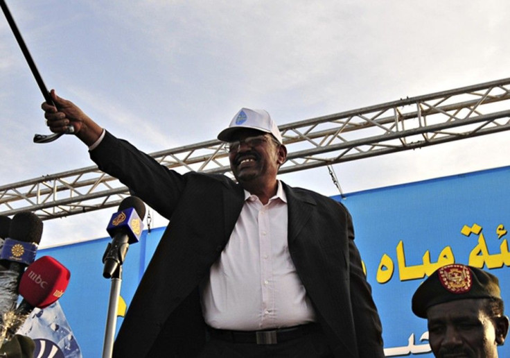 Sudan's President al-Bashir waves to the crowd during rally in Kararey locality at Omdurman