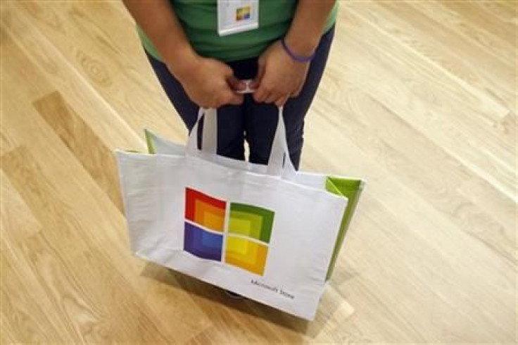A worker holds a bag during the grand opening of Microsoft&#039;s first retail store in Scottsdale