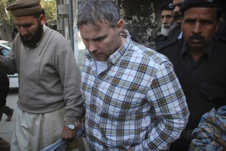 U.S. consulate employee Raymond Davis is escorted by police and officials out of court after facing a judge in Lahore, January 28, 2011. 
