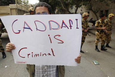 An Egyptian protester holds up a sign during a demonstration outside the Libyan Embassy in Cairo