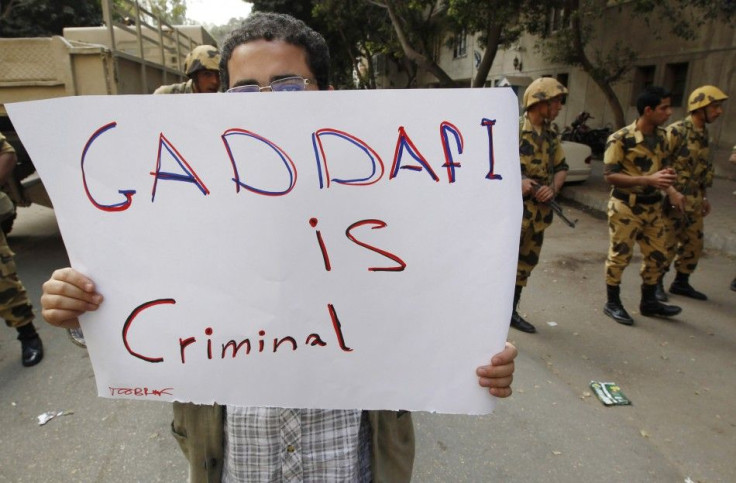 An Egyptian protester holds up a sign during a demonstration outside the Libyan Embassy in Cairo