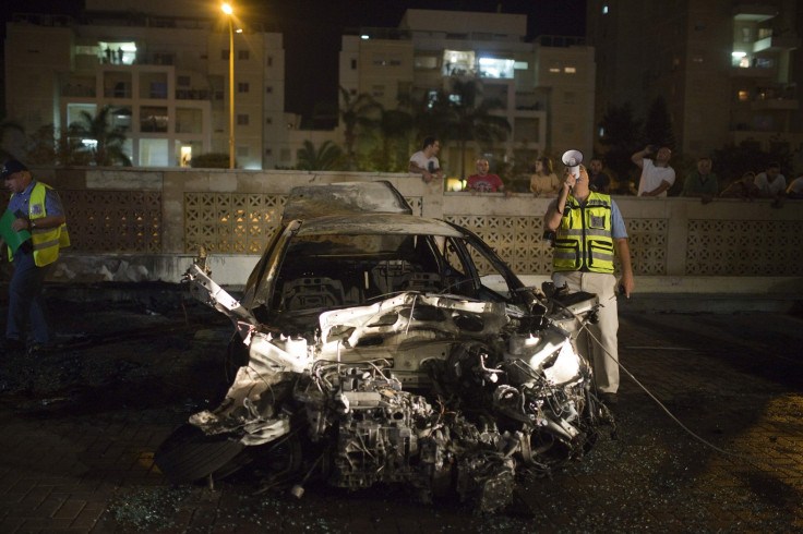 Israeli security beside bombed car