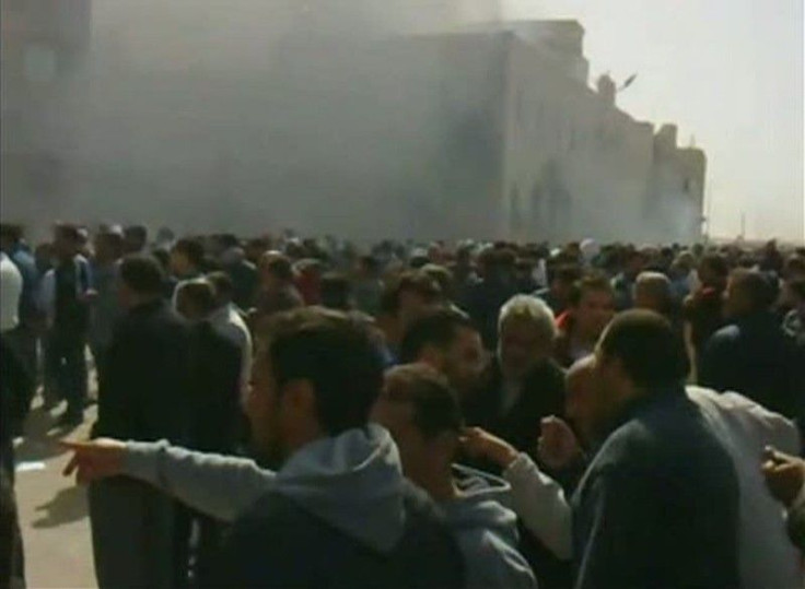 Frame grab shows a crowd gathering as smoke billows from a building in Benghazi