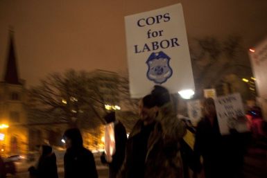 Police officers show their support for fellow union workers as they march around the state Capitol in Madison in protest against Republican Governor Scott Walker's proposed legislation
