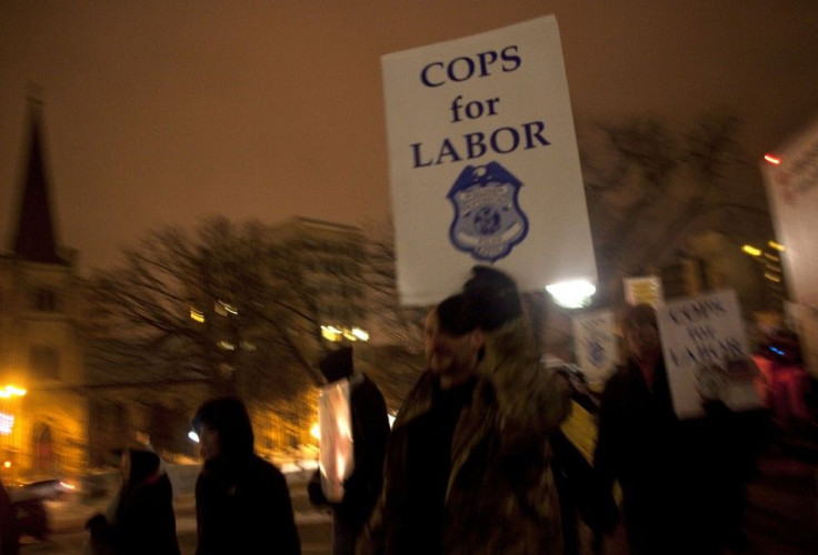 Police officers show their support for fellow union workers as they march around the state Capitol in Madison in protest against Republican Governor Scott Walker's proposed legislation