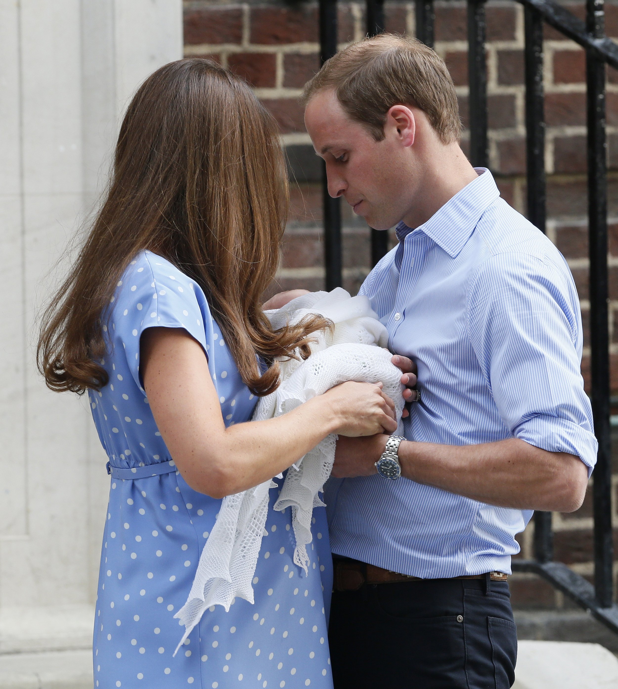 Kate Middleton giving Prince George to Prince William