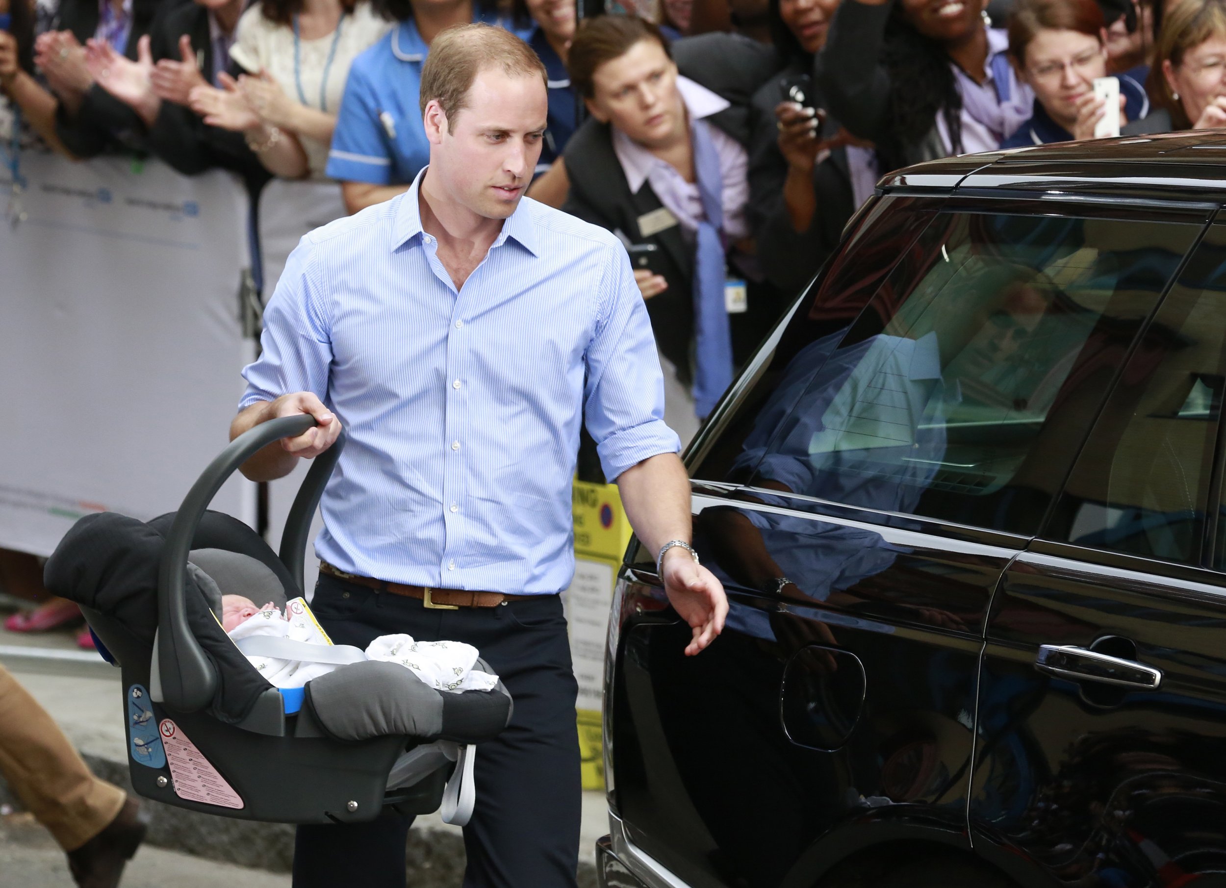 Prince William carries Prince George in car seat