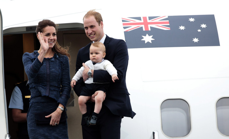 Prince William carrying Prince George