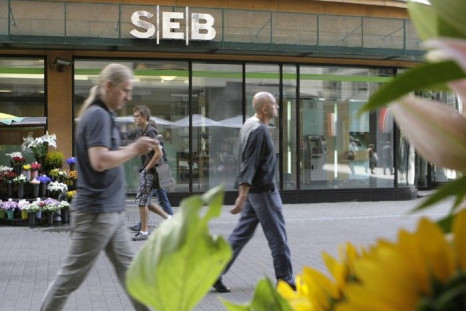 People walk past a SEB bank branch in Riga