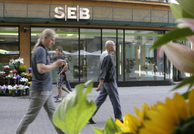 People walk past a SEB bank branch in Riga