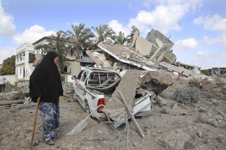 Palestinian walks by home destroyed by Israeli air strike
