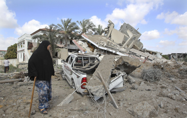 Palestinian walks by home destroyed by Israeli air strike