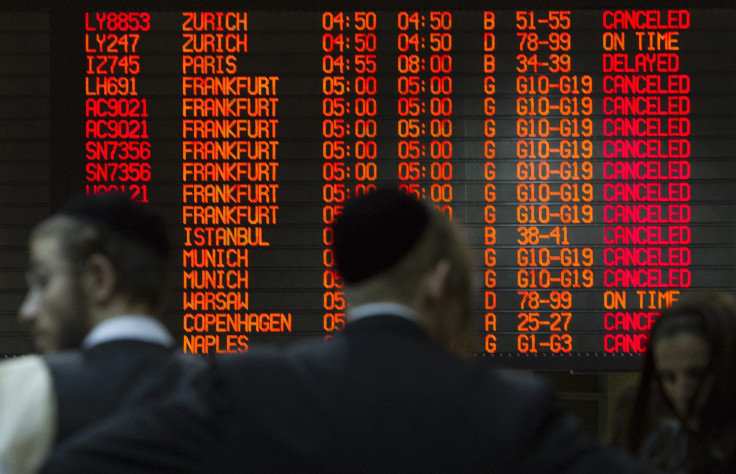 A departure time flight board displays various cancellations as passengers stand nearby at Ben Gurion International airport in Tel Aviv July 22, 2014. 