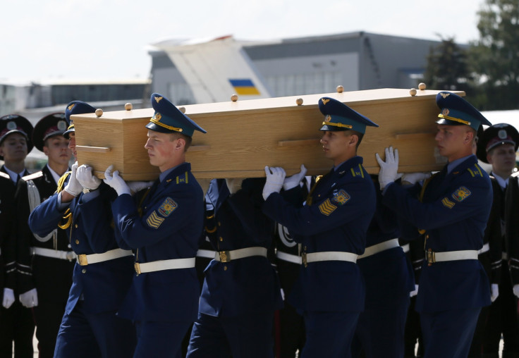 Honour guards carry a coffin of one of the victims of Malaysia Airlines MH17