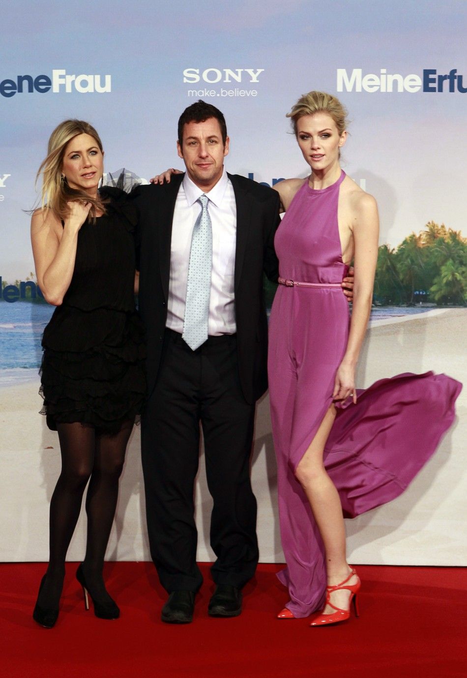 Aniston, Sandler and Decker pose on the red carpet as they arrive for the German premiere of the movie Just Go With It in Berlin February 21, 2011