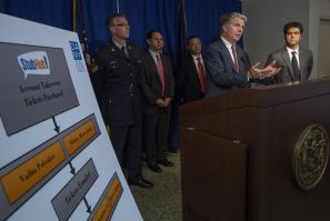 Manhattan District Attorney Cyrus Vance Jr. (2nd R) speaks during a news conference at his office in midtown Manhattan in New York July 23, 2014.