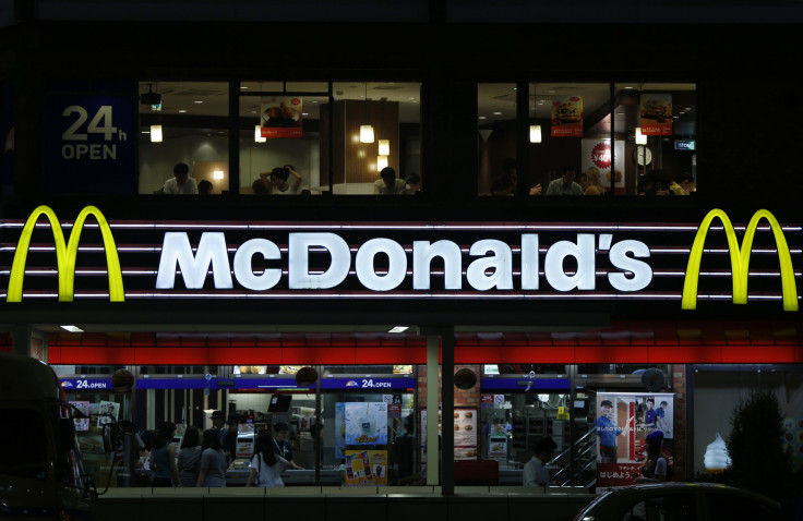 Customers are seen through the windows of a McDonald's store (top) in Tokyo, while others stand in line in front of cash registers, July 22, 2014