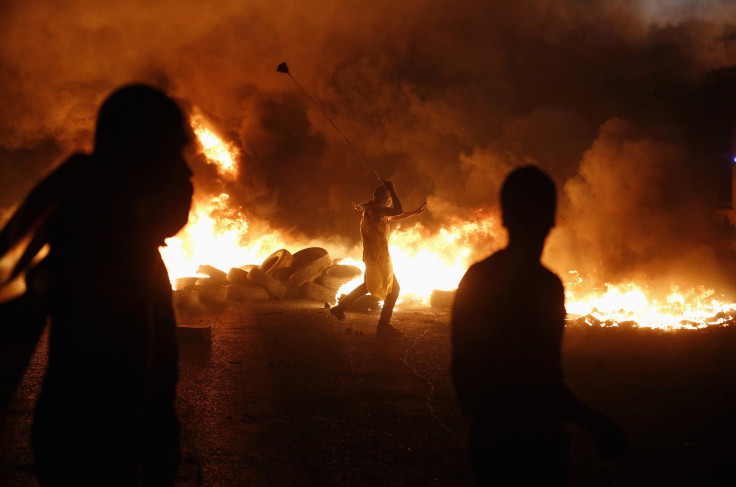 Palestinian protester hurling stone