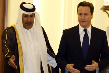 British Prime Minister David Cameron arrives for a news conference with Qatar's Prime Minister Sheikh Hamad bin Jassim bin Jaber al-Thani