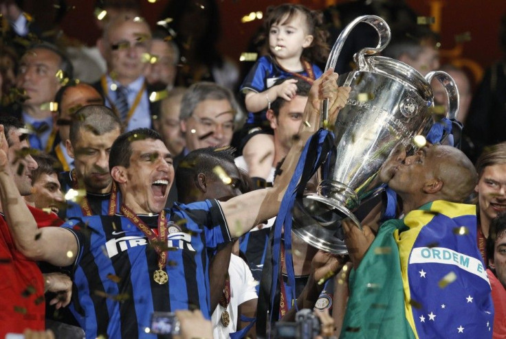 Inter Milan's Lucio and Maicon celebrate with the trophy following their team's Champions League final soccer match victory against Bayern Munich at the Santiago Bernabeu stadium in Madrid, May 22, 2010.