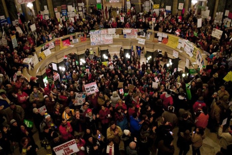 Protestors fill the rotunda outside of Wisconsin Governor Scott Walker's office in Madison