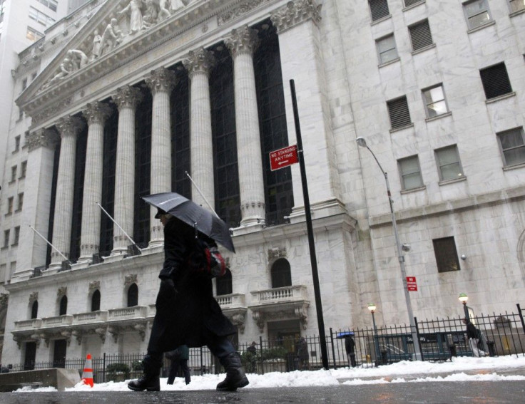 A man walks past New York Stock Exchange in New York during the morning commute