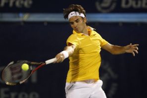 Federer of Switzerland hits a return to Marcel Granollers during their match at the ATP Dubai Tennis Championships.