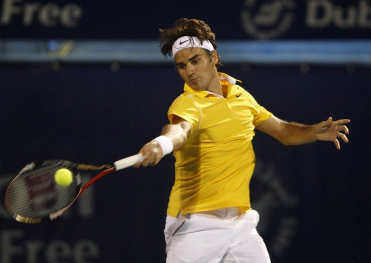 Federer of Switzerland hits a return to Marcel Granollers during their match at the ATP Dubai Tennis Championships.