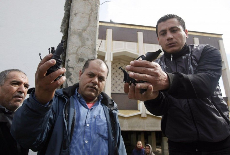 Anti-government demonstrators show hand grenades, which were used by troops loyal to Libyan leader Muammar Gaddafi while fighting with demonstrators, in Benghazi city