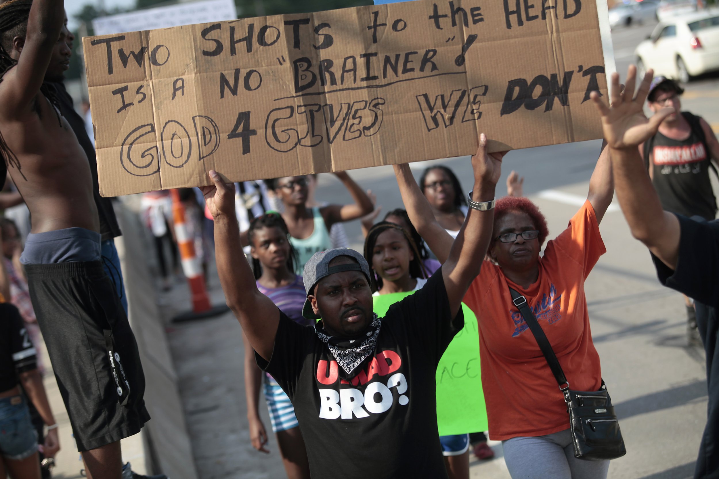Ferguson protesters hold signs