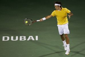 Federer of Switzerland hits a return to Stakhovsky of Ukraine during their quarter-final match at the ATP Dubai Tennis Championships.