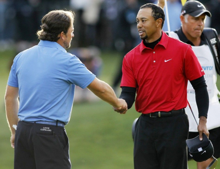 Woods and McDowell shake hands after McDowell won the Chevron World Challenge golf tournament on a playoff hole in Thousand Oaks.