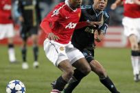Olympique Marseille's Remy challenges Manchester United's Evra during their Champions League soccer match at the Velodrome stadium in Marseille