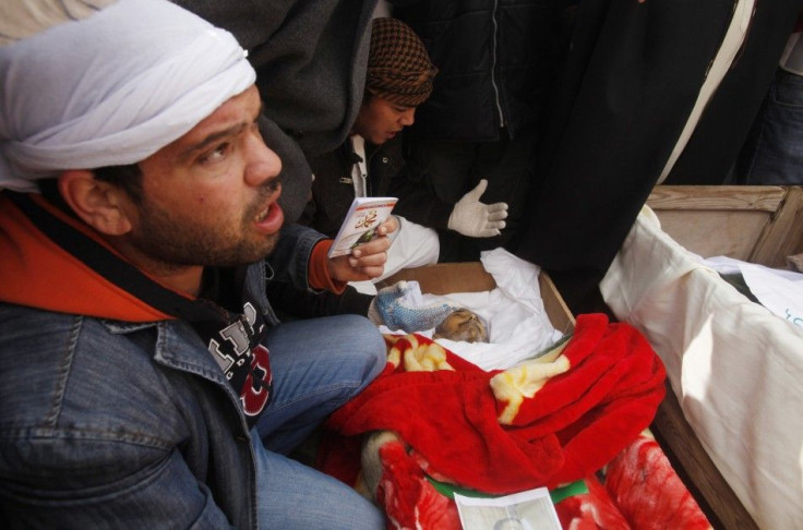 Mourners gather near the coffins of Libyans who were killed in recent clashes in Benghazi