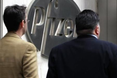People walk past the Pfizer World headquaters in New York