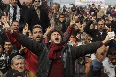 Anti-Gaddafi protesters chant slogans during a protest in Benghazi, Libya on February 25, 2011. 