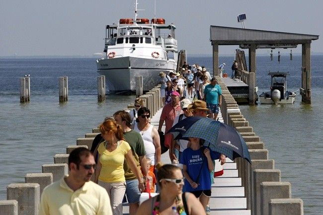 Tourists arrive to spend the day on West Ship Island, as BP contractors laid boom offshore to contain an oil spill off the coast of Gulfport, Mississippi May 6, 2010.
