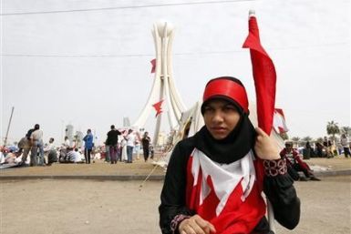 A protester sits near Pearl Square in Bahraini 