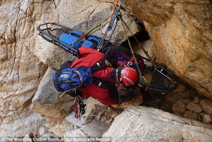 rescue-worker-lowers-stretcher-help-tsenolo-shadrack-rasello-whose-leg-had-be-amputated-after