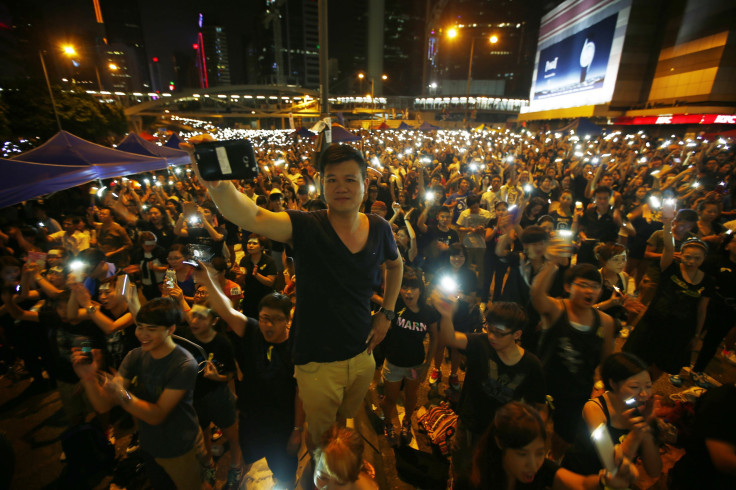 Hong Kong protesters hold mobile devices